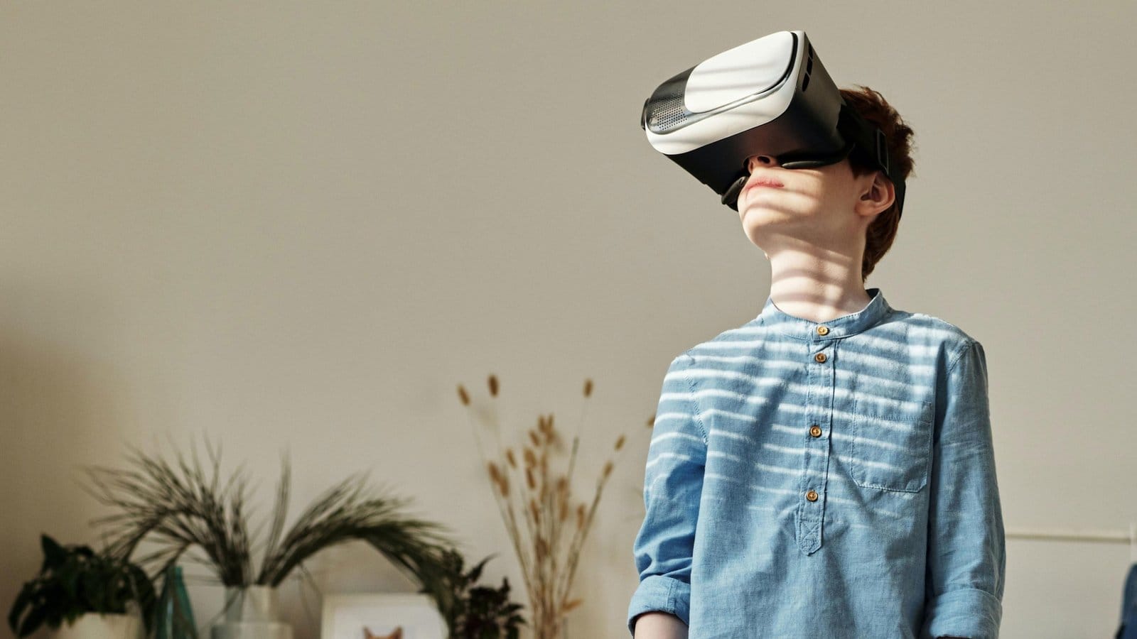 A boy wearing a virtual reality headset